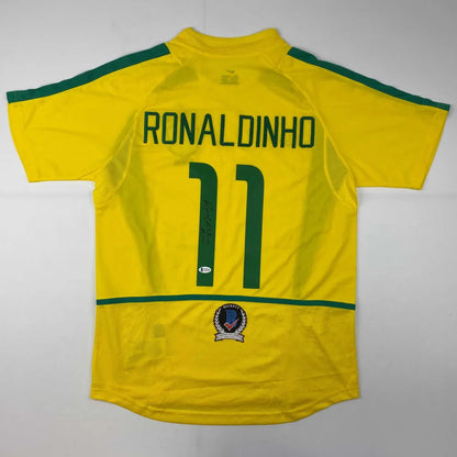 Yellow custom soccer jersey with green accents, Ronaldinho signed, pro sports league gear