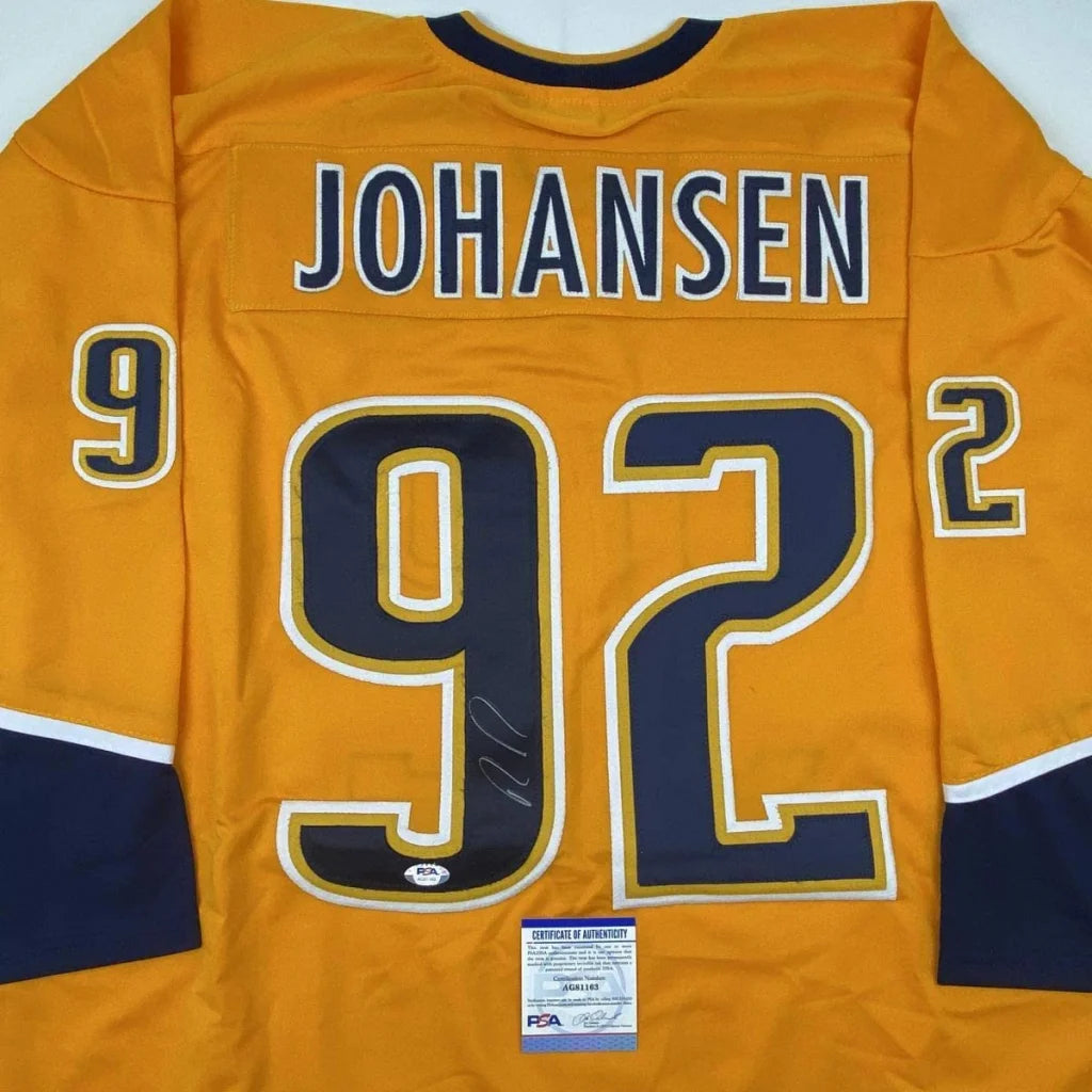 Back view of vibrant orange autographed ryan johansen nashville custom jersey with navy blue and gold trim for professional sports league