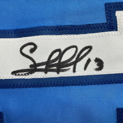 Autographed blue custom jersey from professional sports league with white stripe