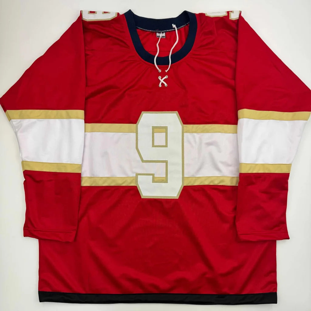 Red custom jersey with white and gold stripes and number 9 from professional sports league