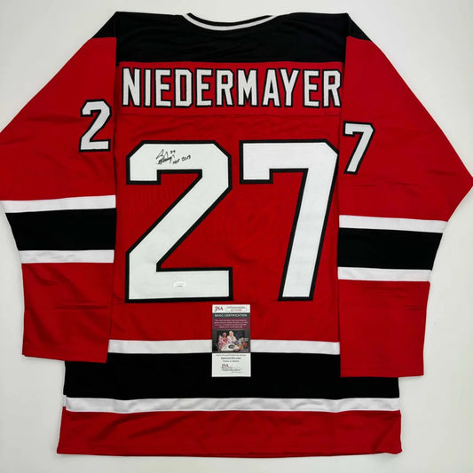 Red and black Niedermayer custom jersey from a pro sports league featuring number 27