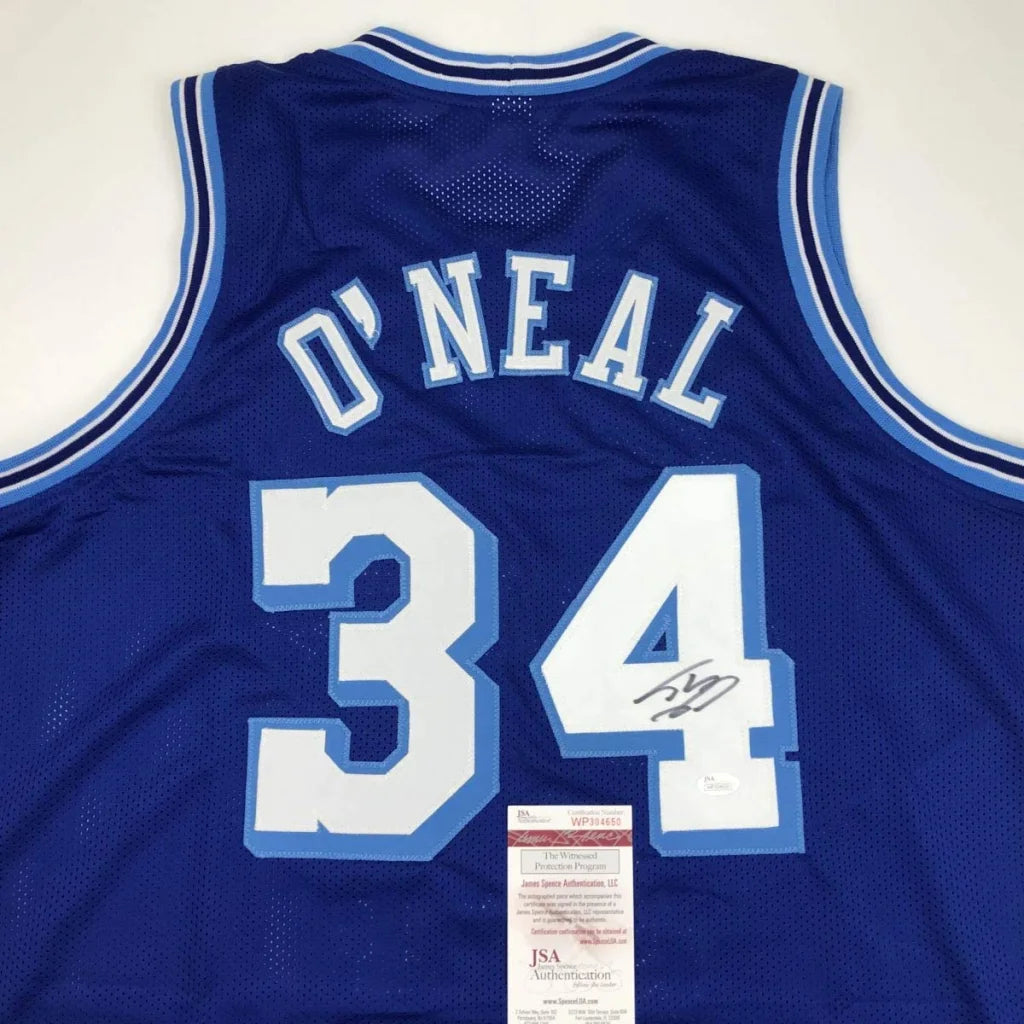 Back view of a blue mesh custom jersey with white and light blue lettering o neal 34 signed for professional sports league use