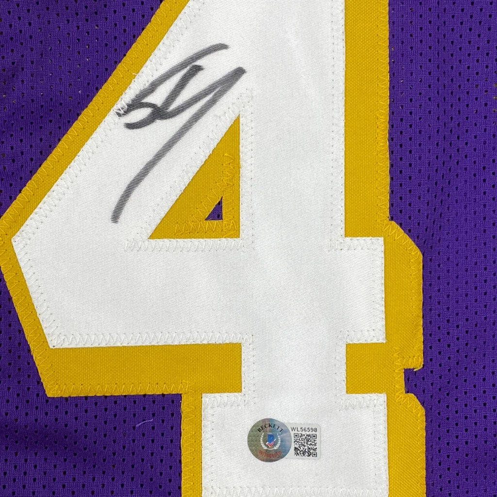 Autographed white and gold number four custom jersey patch signed by shaquille shaq oneal from a professional sports league