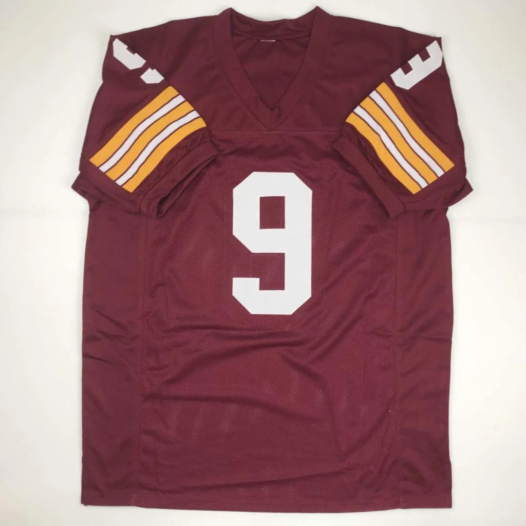 Autographed burgundy custom jersey with white number 9 and gold white striped sleeves from professional sports league