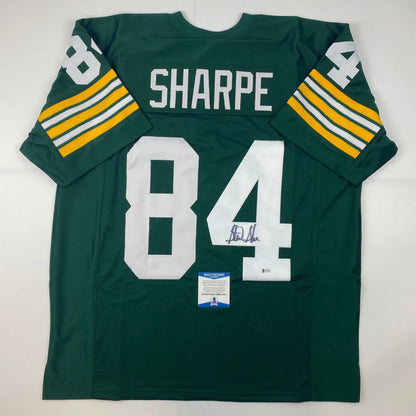 Autographed sterling sharpe green bay custom jersey in green white with yellow stripes from a professional sports league