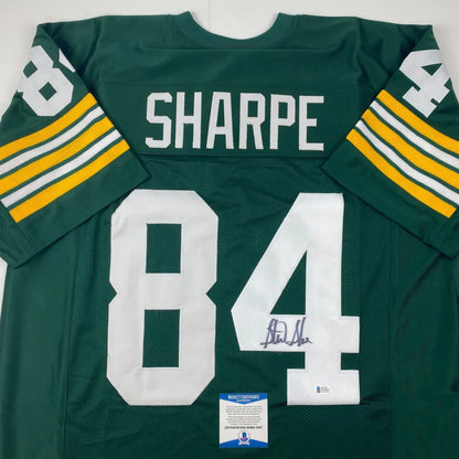 Back of autographed sterling sharpe green bay green and yellow custom jersey with white lettering and number 84 from professional sports league