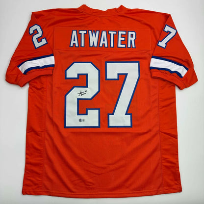 Orange custom jersey with number 27 and signature from a professional sports league