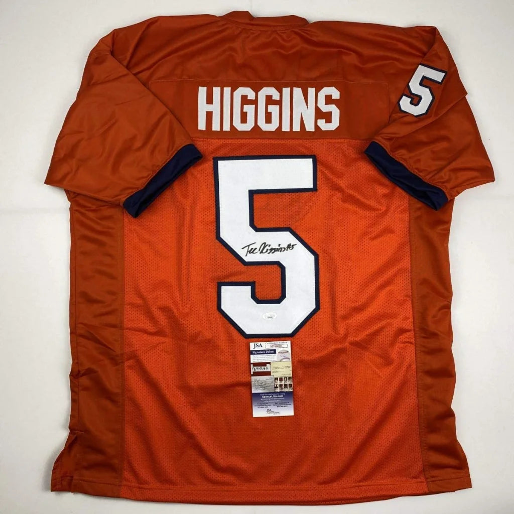 Back of an orange custom jersey featuring white number 5 and signed by tee higgins from professional sports league