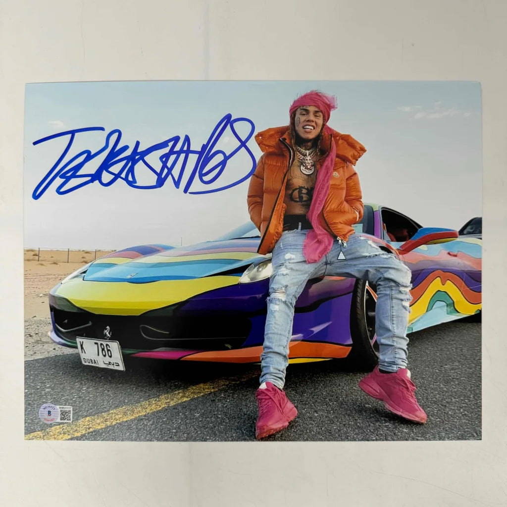 Autographed Tekashi 6ix9ine photo with a vibrant colorful car in the background