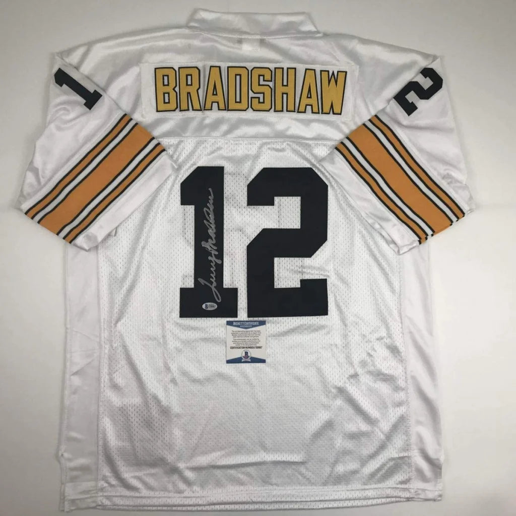 Back view of autographed professional sports white football jersey with gold and black bradshaw 12 lettering