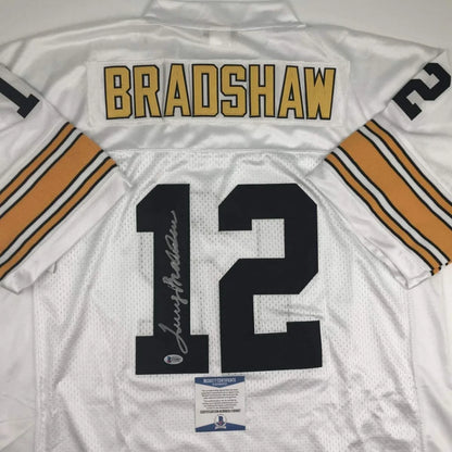 Back view of white custom football jersey with gold and black lettering bradshaw 12 signed for professional sports league fans