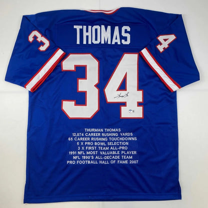 Back of blue custom jersey signed by thurman thomas featuring number 34 and name thomas from professional sports league