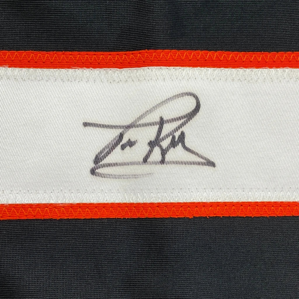 Autographed black and white custom jersey with orange trim from professional sports league