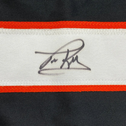 Autographed black and white custom jersey with orange trim from professional sports league