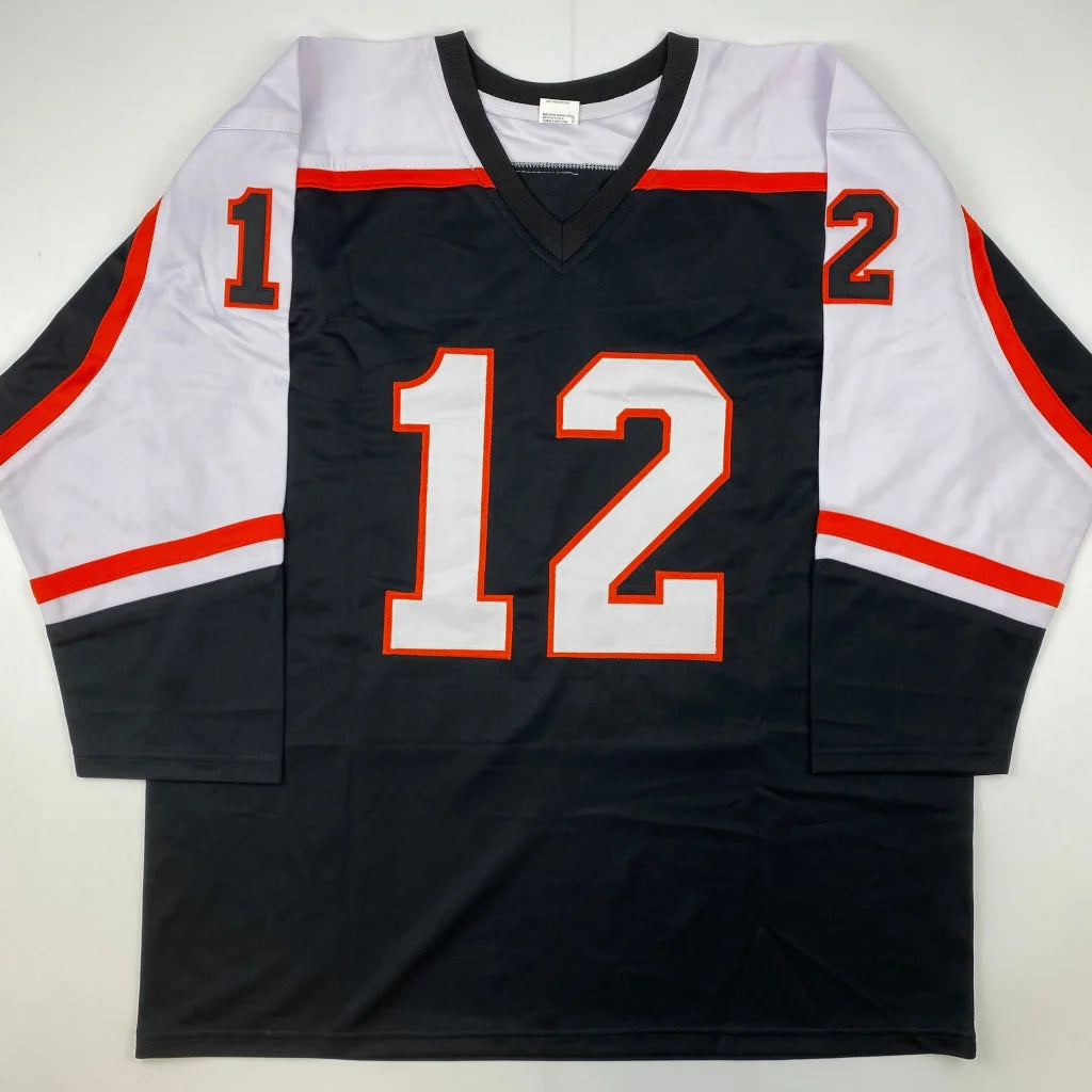 Black and white custom jersey with orange stripes and number 12 from professional sports league