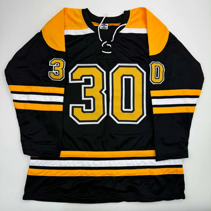 Black and gold custom jersey with white stripes and laces for professional sports fans