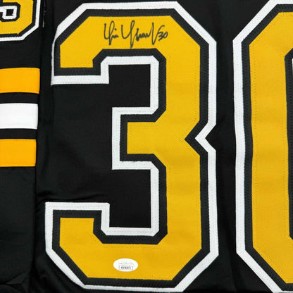 Black sports jersey with gold and white number ’30’’ and an autograph.