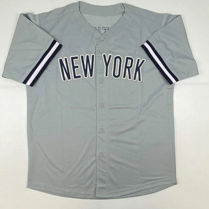 Gray New York Yankees custom jersey with navy and white striped sleeves for professional sports fans