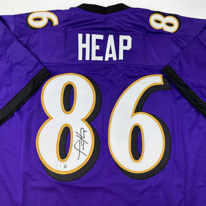 Back of a purple baltimore ravens custom jersey with white and gold number 86 heap name and signature for professional sports league