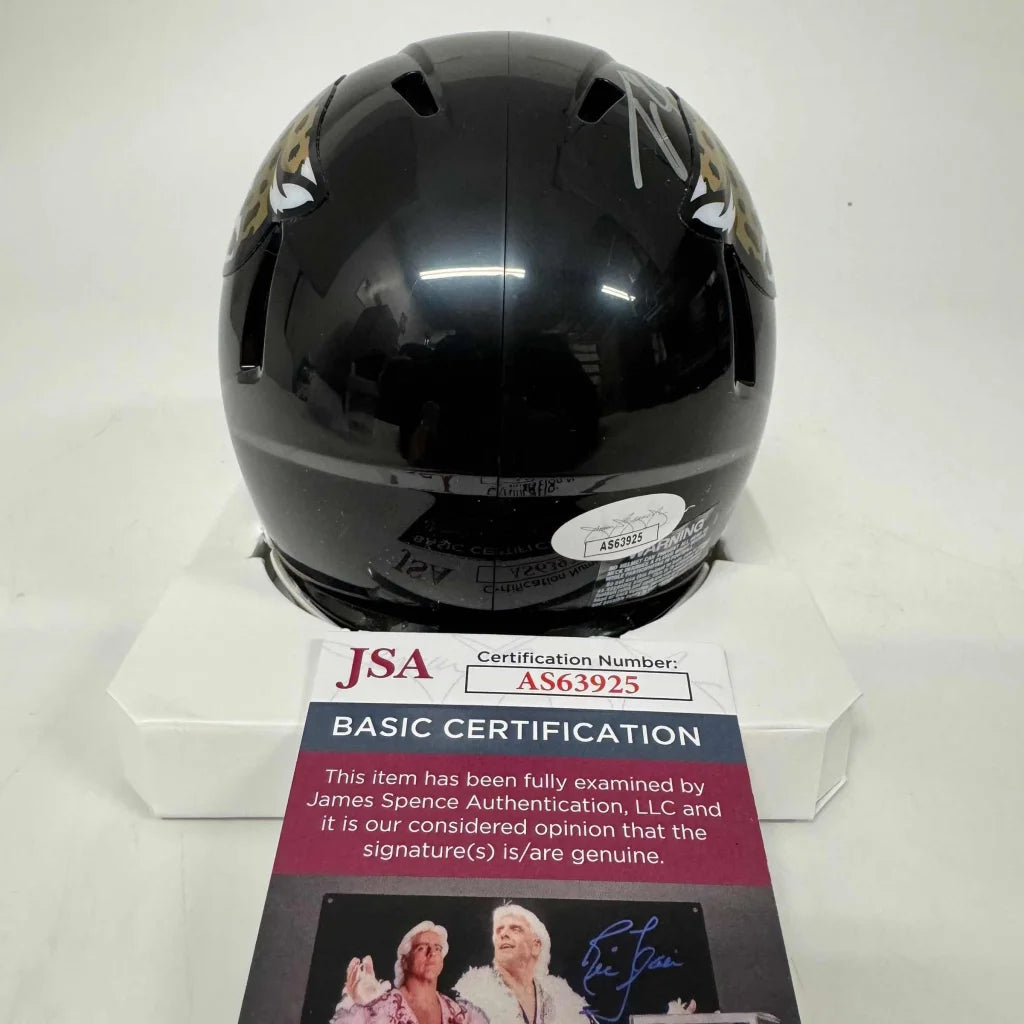 Black Jacksonville Jaguars mini helmet with gold logo and third party authentication