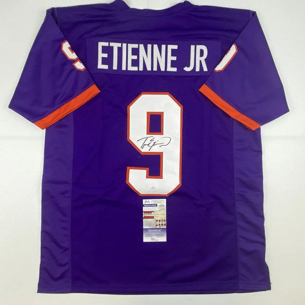 Purple and orange Travis Etienne signed custom jersey with number 9, perfect for sports fans