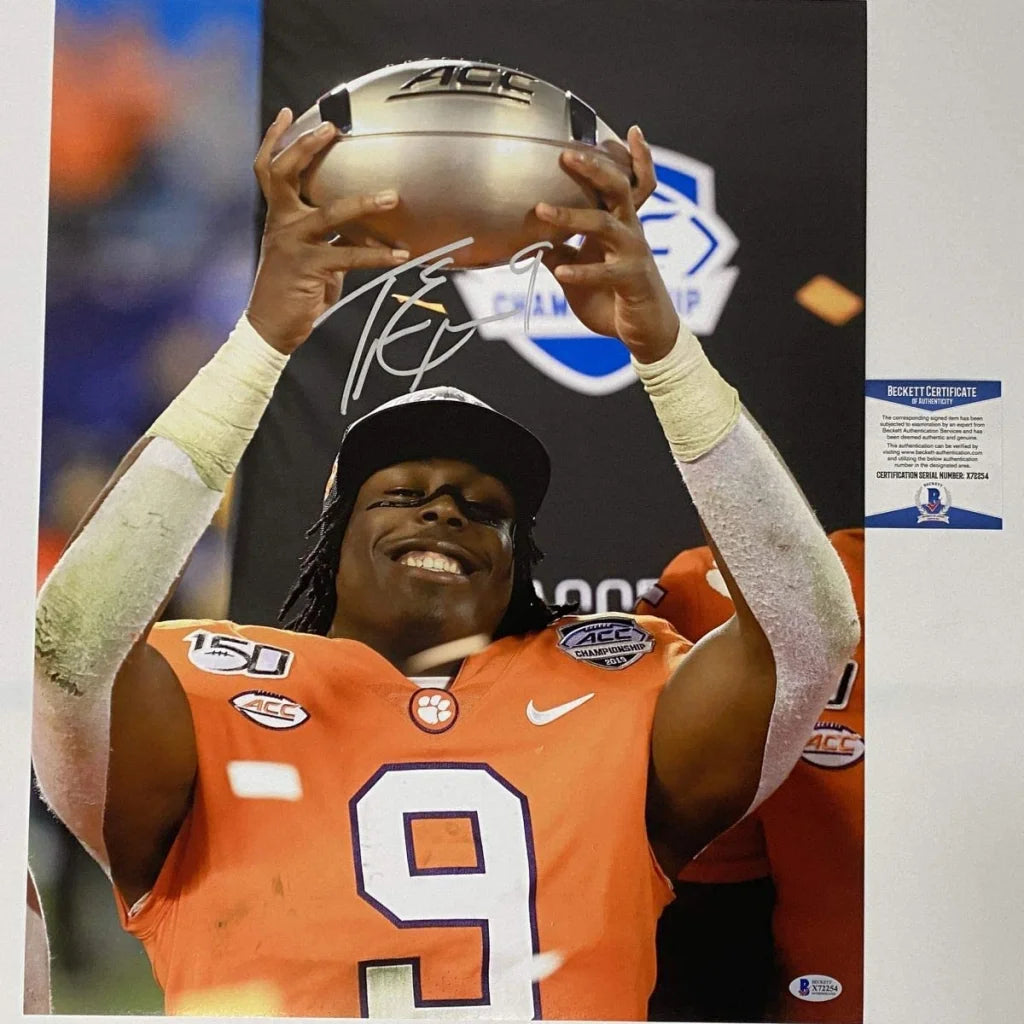 Signed football player photo with championship trophy and third party authentication