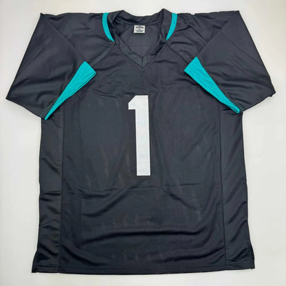 Autographed Travis Etienne Jr. Jacksonville black custom jersey with teal accents
