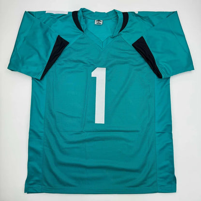 Autographed Travis Etienne Jr. teal custom jersey with white number one