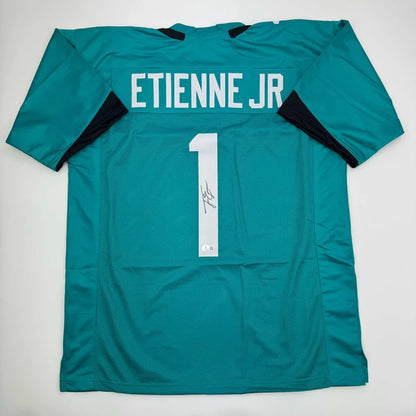 Autographed Travis Etienne Jr. teal custom jersey with signature, NFL pro sports