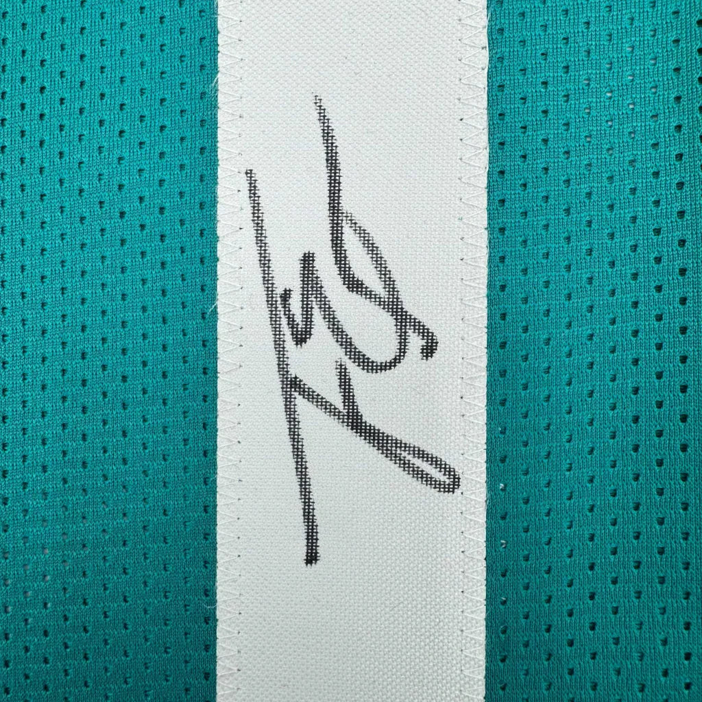 Autographed Travis Etienne Jr. Jacksonville teal custom jersey with black ink signature on white stripe, Beckett BAS COA