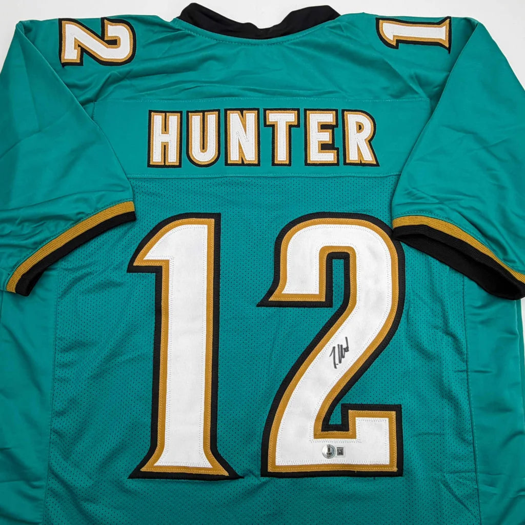 Autographed Travis Hunter Jacksonville Teal Retro Football Jersey Beckett BAS COA | Certified Authentic Signed Memorabilia | vintageantiquesgifts.com