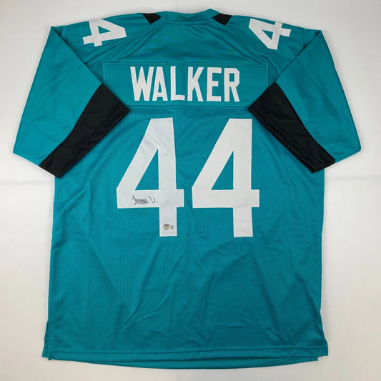 Teal football jersey with black sleeves and white numbers from Authentic WALKER 44 sports league