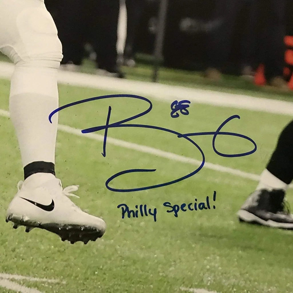 White Nike football cleat with black swoosh beside autographed Trey Burton Philly Special Eagles photo