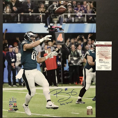 Autographed Eagles player catching football with third party authentication sticker on cleat