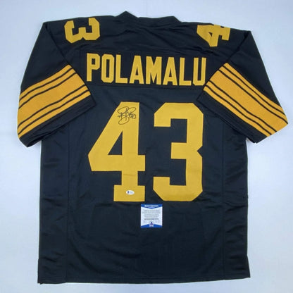 Black and gold professional sports league custom jersey signed by Troy Polamalu with authentication sticker
