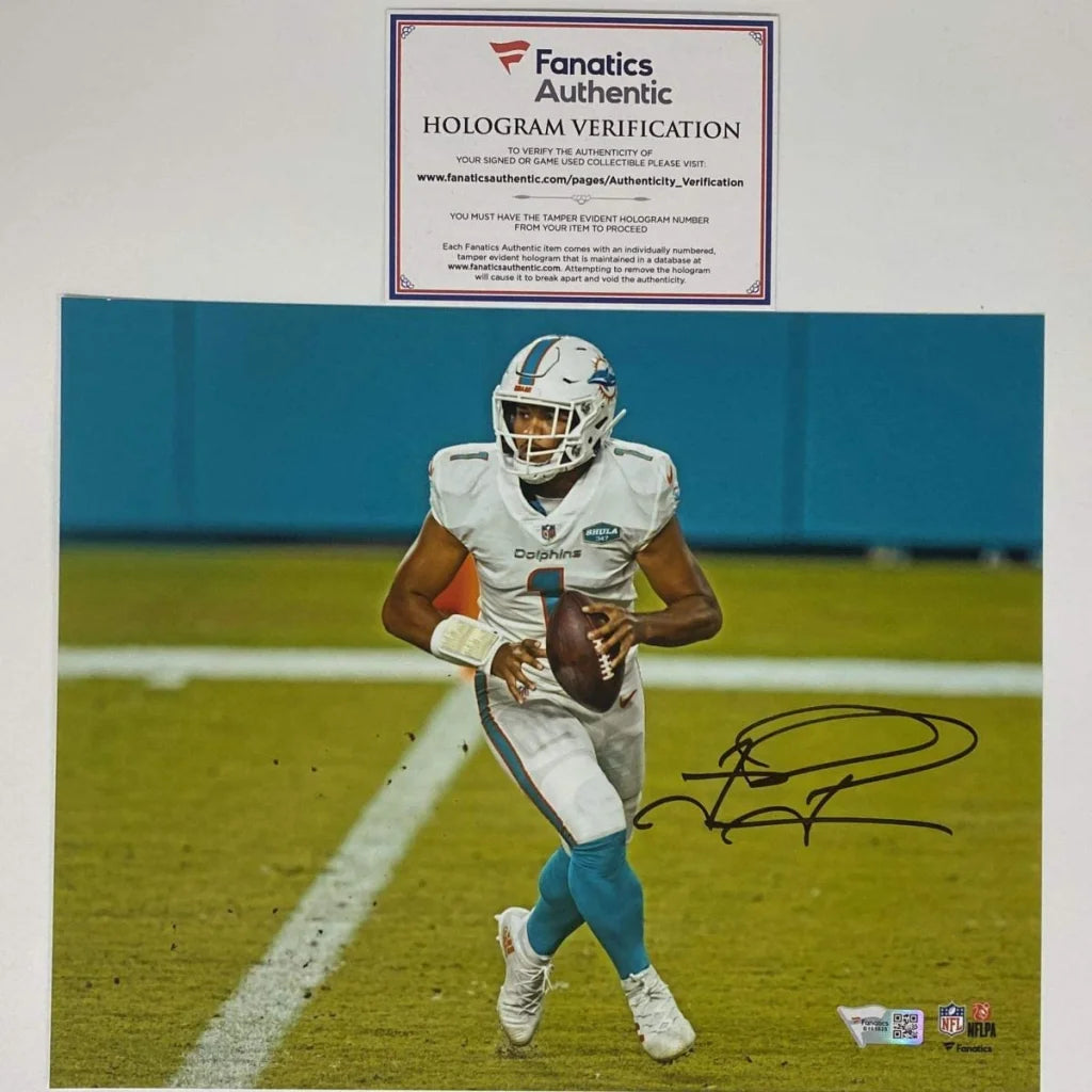 Autographed football player photo in white and teal uniform with third-party verification