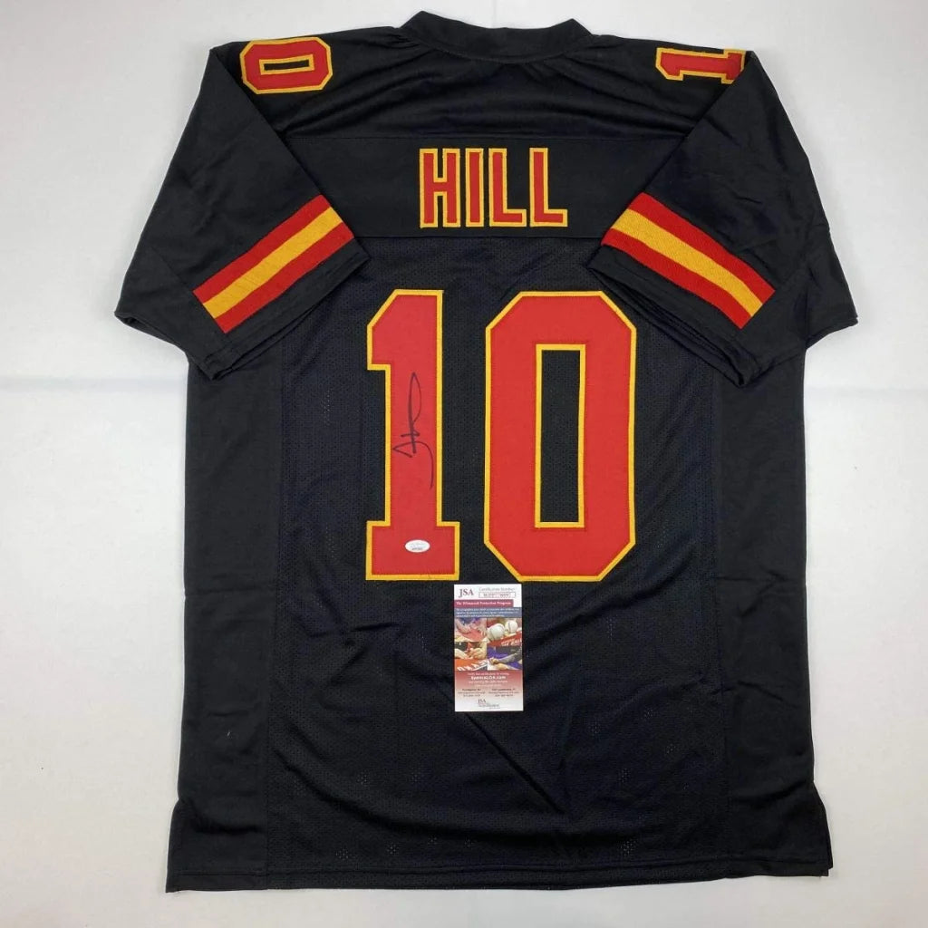 Back of autographed tyreek hill kansas city black football custom jersey with red and yellow numerals from professional sports league