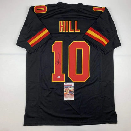 Back of autographed tyreek hill kansas city black football custom jersey with red and yellow numerals from professional sports league