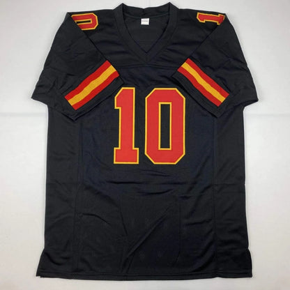 Autographed Tyreek Hill custom black football jersey with red yellow number 10 and sleeve stripes from professional sports league
