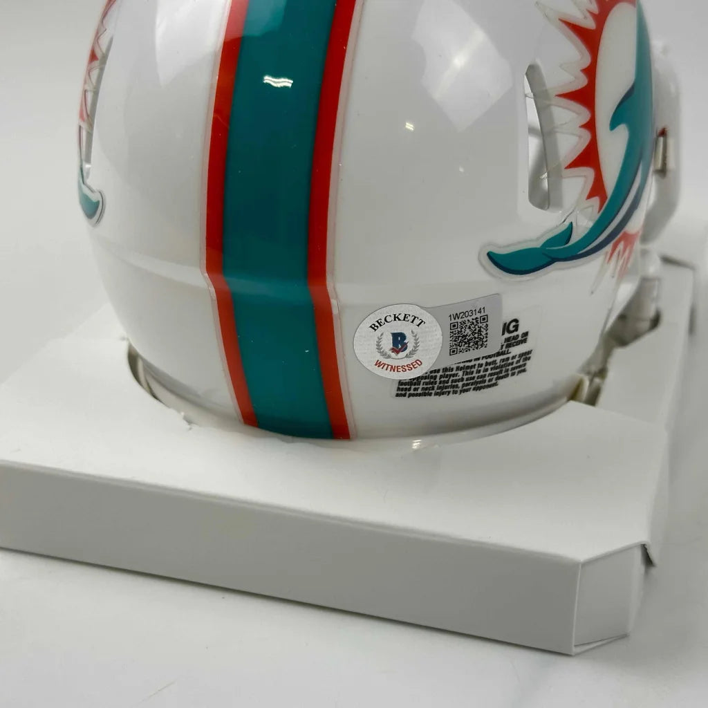 White Miami Dolphins mini helmet with teal and orange stripes and player autograph