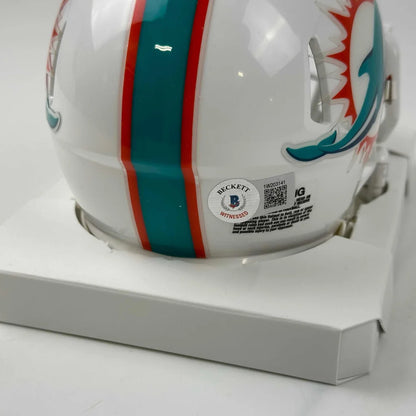 White Miami Dolphins mini helmet with teal and orange stripes and player autograph