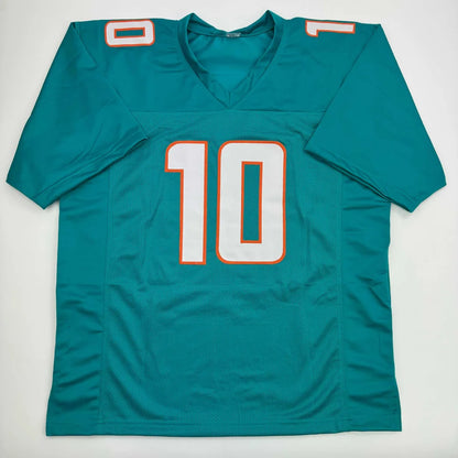 Teal professional sports league custom jersey with white and orange number 10