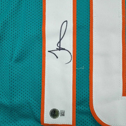 Teal and white custom jersey with autograph and holographic sticker from professional sports league
