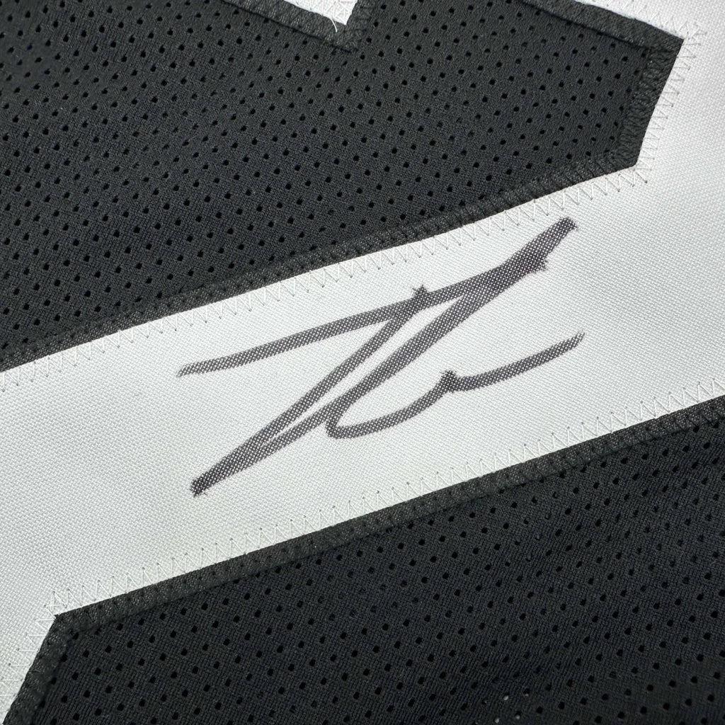 Black custom jersey with white stripe and signature from a professional sports league