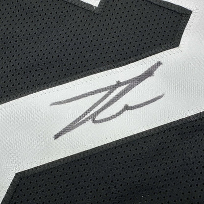 Black custom jersey with white stripe and signature from a professional sports league