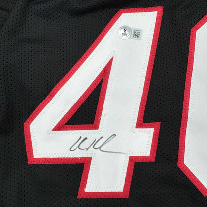 Black professional sports league jersey with red white number 41 and Beckett BAS COA