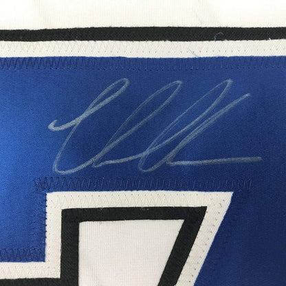 Blue custom jersey with white autograph from a professional sports league team