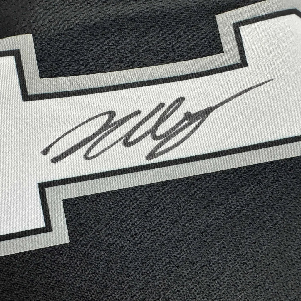 Black athletic jersey with white and grey stripe and Wembanyama signature, third party authentication
