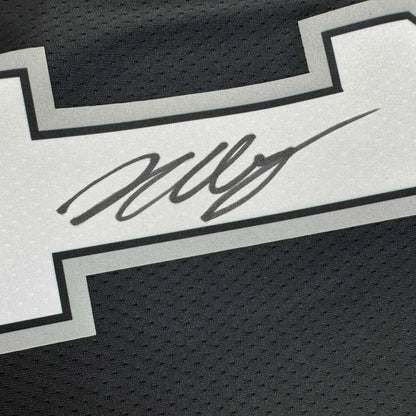 Black athletic jersey with white and grey stripe and Wembanyama signature, third party authentication