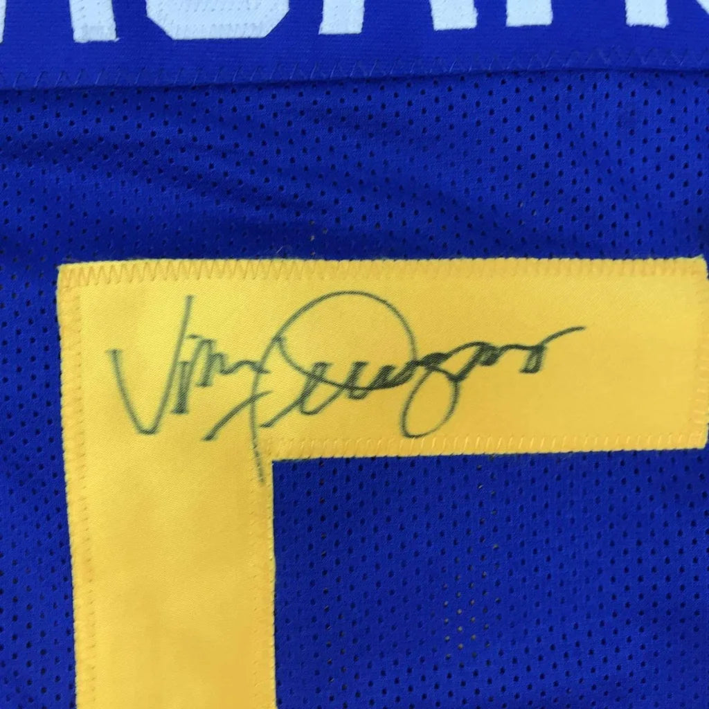 Autographed blue custom jersey with yellow numbers from a professional sports league